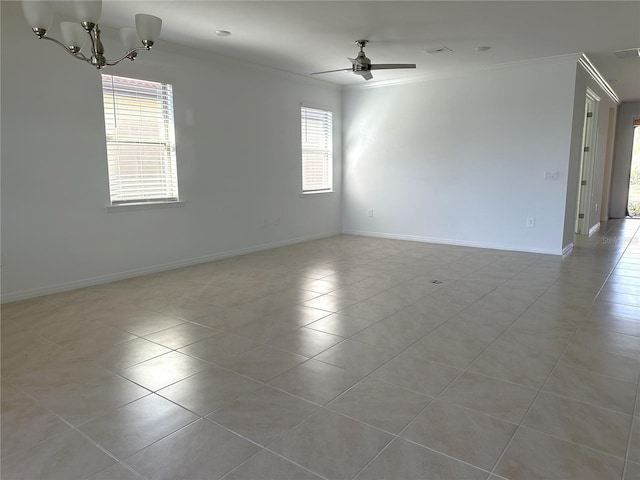 empty room with ornamental molding, plenty of natural light, ceiling fan with notable chandelier, and light tile floors