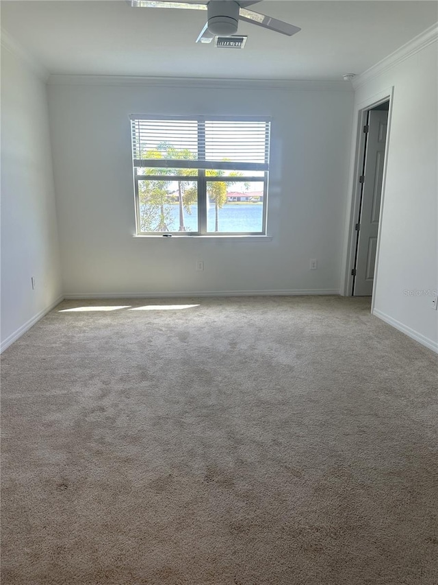 empty room featuring light colored carpet, ceiling fan, and ornamental molding