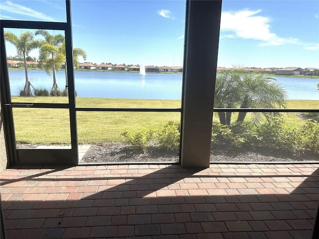 unfurnished sunroom with a water view