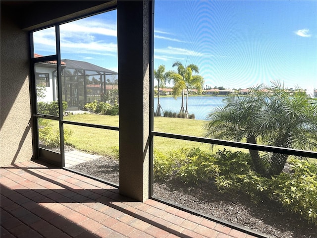 unfurnished sunroom with a water view