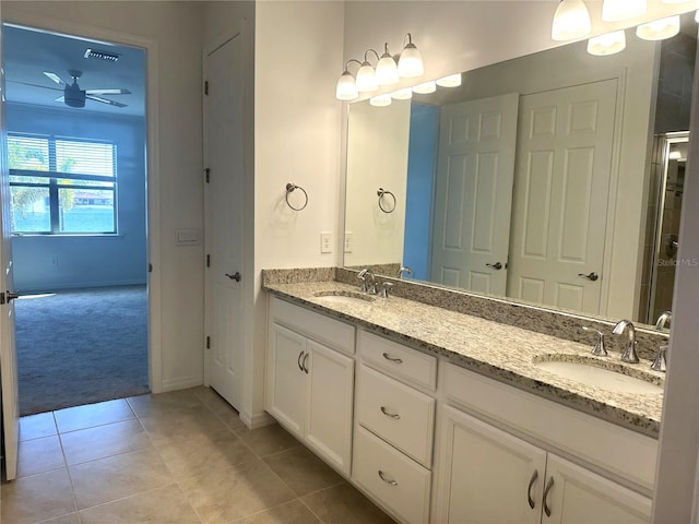 bathroom with large vanity, ceiling fan, double sink, and tile flooring