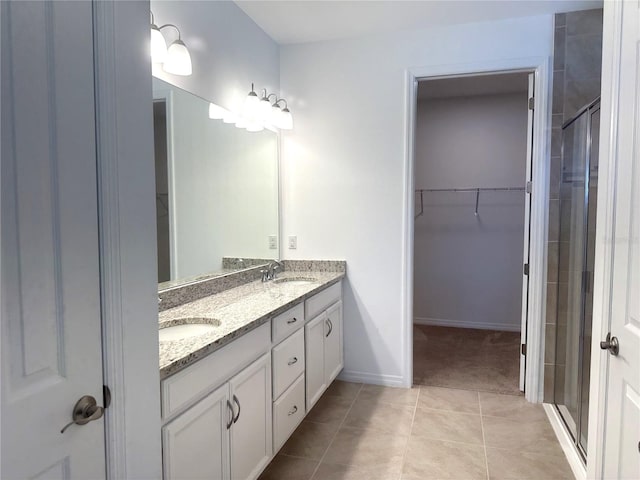 bathroom with double sink, an enclosed shower, oversized vanity, and tile flooring