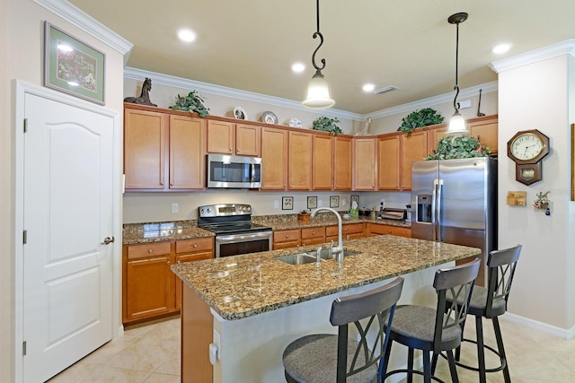 kitchen featuring pendant lighting, stainless steel appliances, sink, and light tile floors