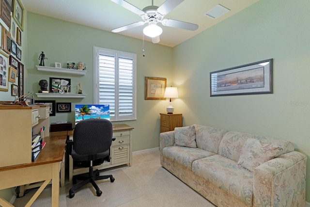 carpeted office space with ceiling fan and a fireplace