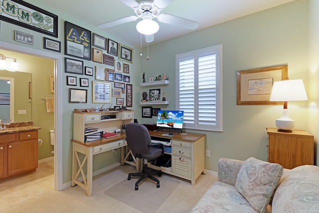 carpeted office space with ceiling fan