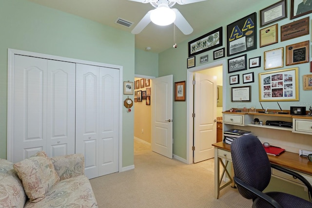 home office featuring light carpet and ceiling fan