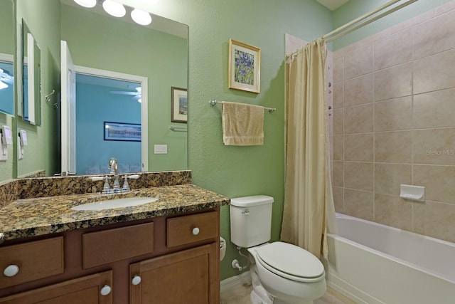 full bathroom with large vanity, shower / tub combo, and toilet