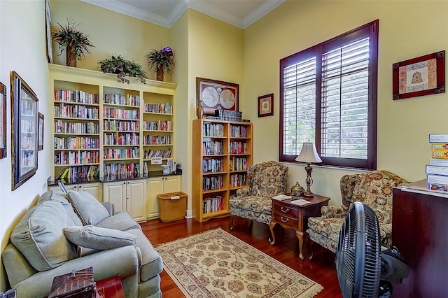 living area featuring dark wood-type flooring and ornamental molding