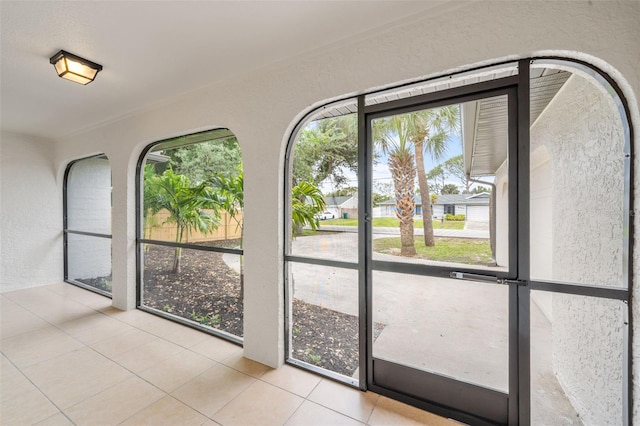 doorway to outside with light tile patterned floors