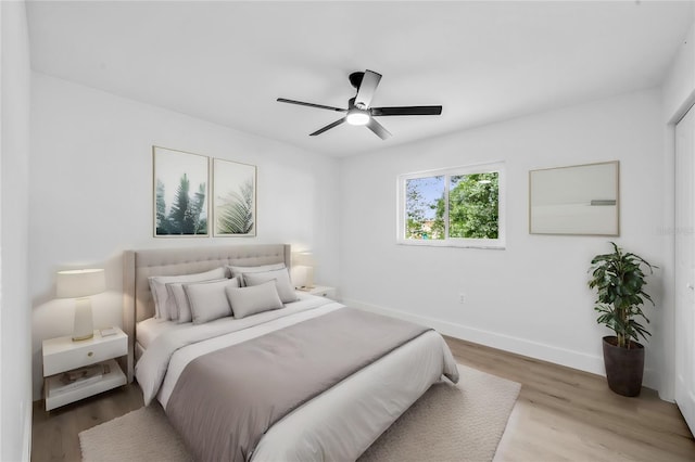 bedroom with light hardwood / wood-style flooring and ceiling fan