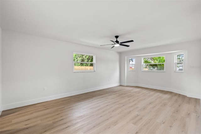 spare room featuring light hardwood / wood-style flooring and ceiling fan