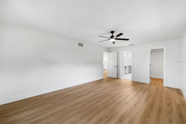 unfurnished bedroom with ceiling fan, a closet, light wood-type flooring, and a spacious closet