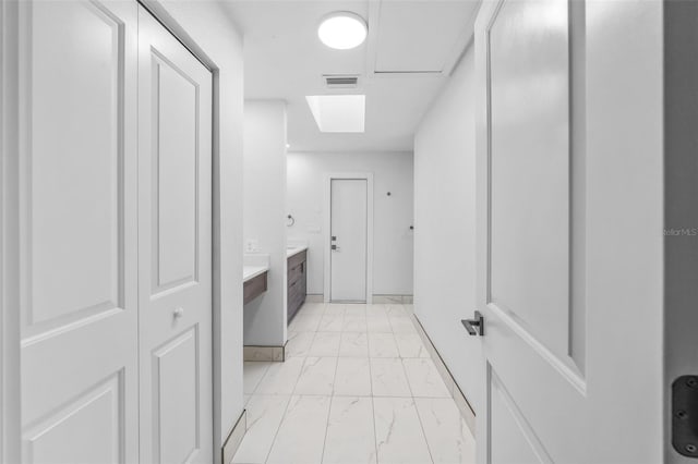 corridor with light tile patterned floors