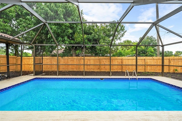 view of pool featuring glass enclosure