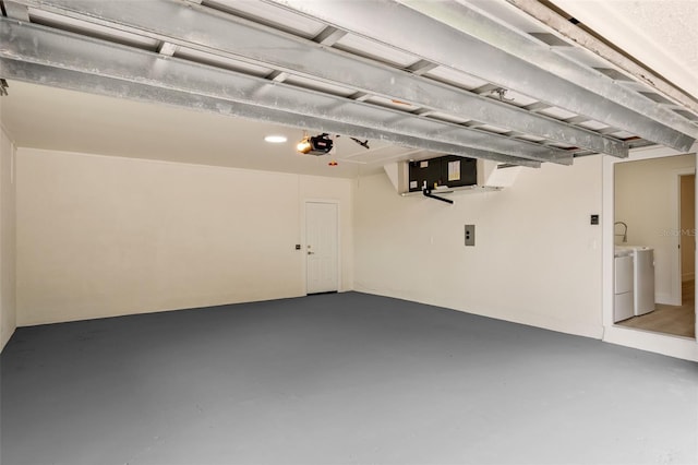 garage featuring washer and dryer and a garage door opener