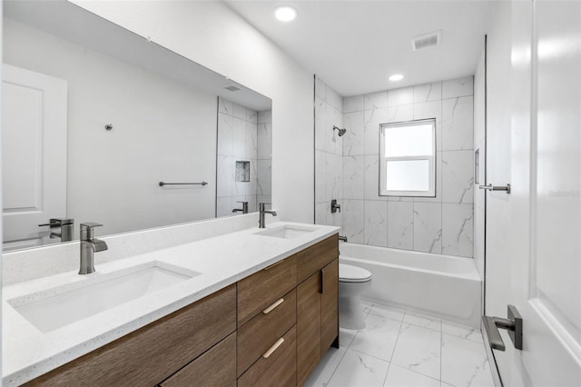 full bathroom featuring tile patterned flooring, toilet, tiled shower / bath, and dual bowl vanity