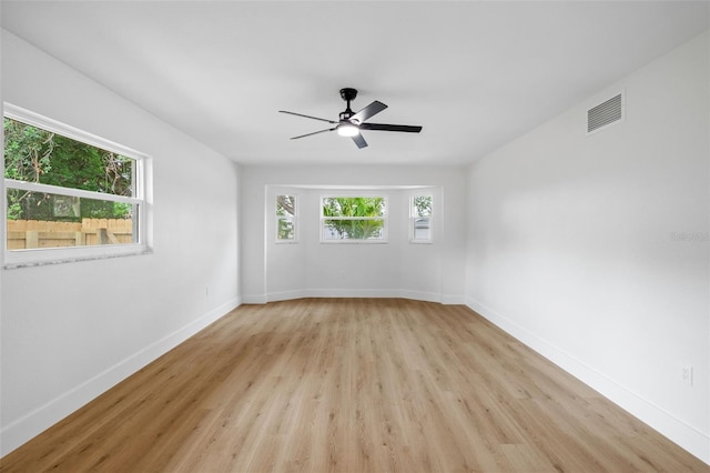 unfurnished room featuring ceiling fan, light hardwood / wood-style floors, and plenty of natural light