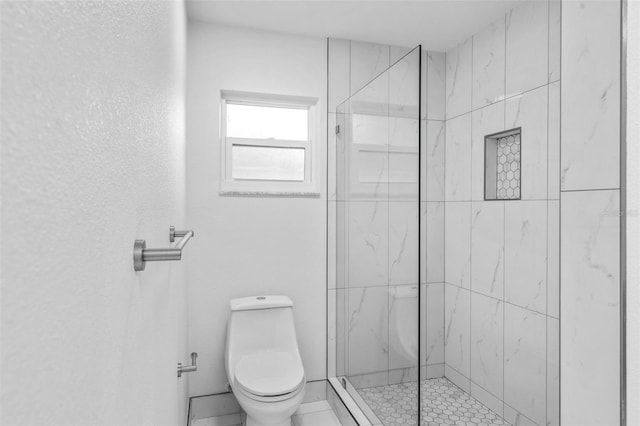 bathroom featuring walk in shower and toilet