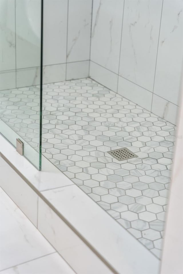 details with tile patterned flooring and a shower