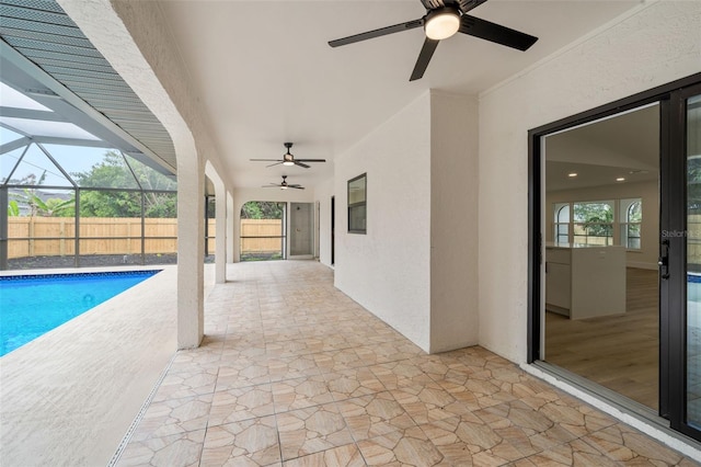 view of patio with a lanai, a fenced in pool, and ceiling fan