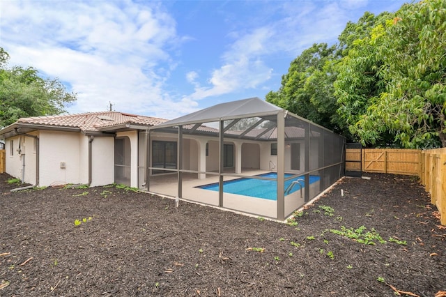 view of swimming pool with a patio and glass enclosure