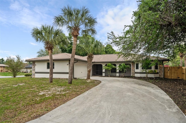 ranch-style house with a garage and a front yard