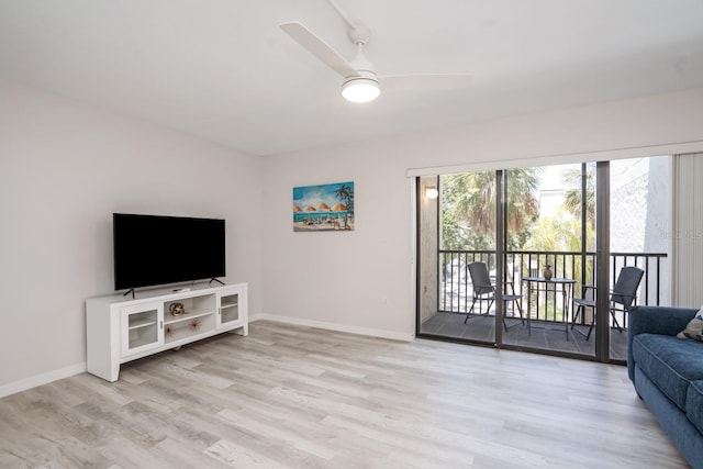 living room with light hardwood / wood-style floors and ceiling fan