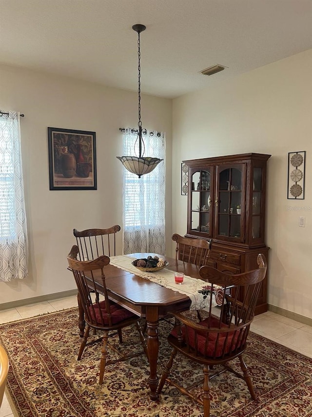 dining space with light tile floors