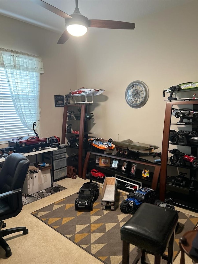 home office featuring light colored carpet and ceiling fan