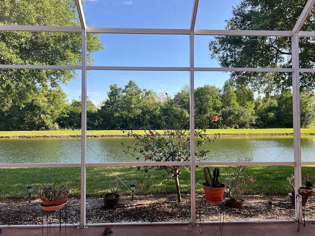 unfurnished sunroom featuring a water view