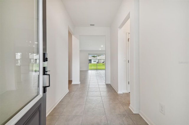 hall featuring light tile patterned flooring