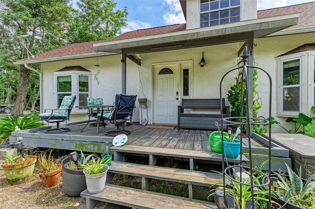 property entrance with a deck