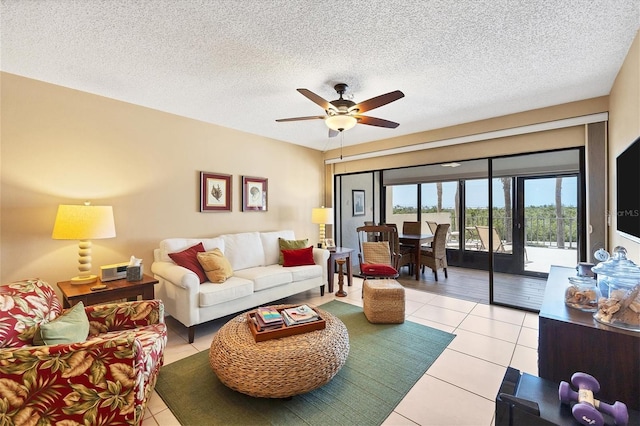 living room featuring french doors, ceiling fan, a textured ceiling, and light tile flooring