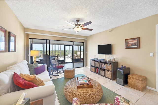 tiled living room featuring a textured ceiling and ceiling fan