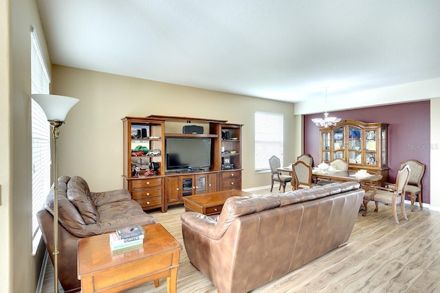 living room with a chandelier and light wood-type flooring