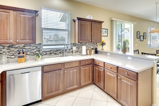 kitchen with sink, dishwasher, backsplash, and light tile flooring