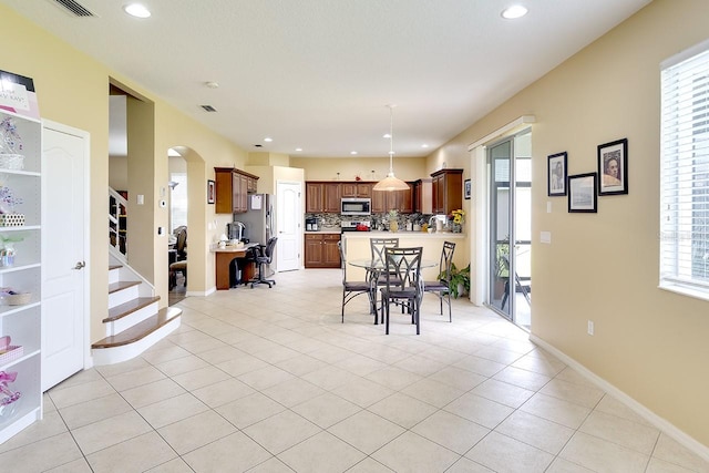 dining space with light tile floors and a wealth of natural light