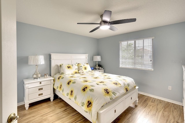 bedroom with light hardwood / wood-style flooring and ceiling fan