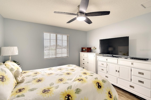 bedroom featuring light hardwood / wood-style flooring and ceiling fan