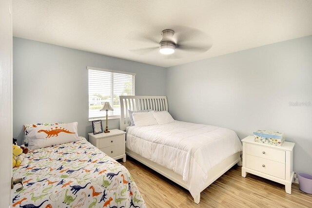 bedroom with light hardwood / wood-style flooring and ceiling fan