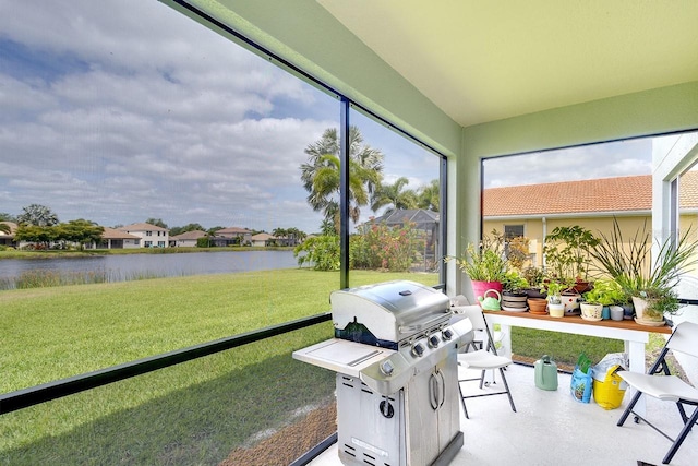 sunroom / solarium with a water view