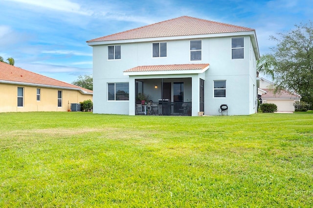 back of property featuring central AC and a lawn