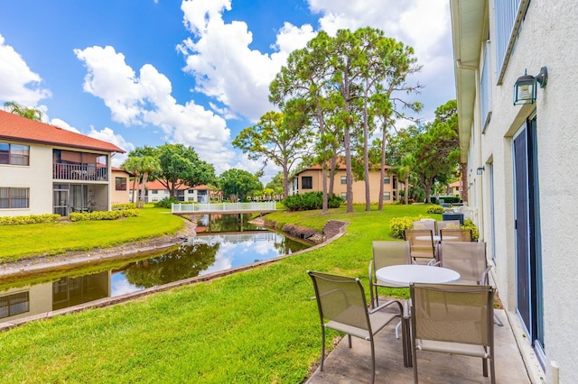 view of yard featuring a balcony and a water view