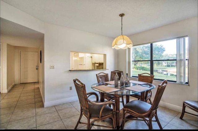 dining space featuring light tile flooring