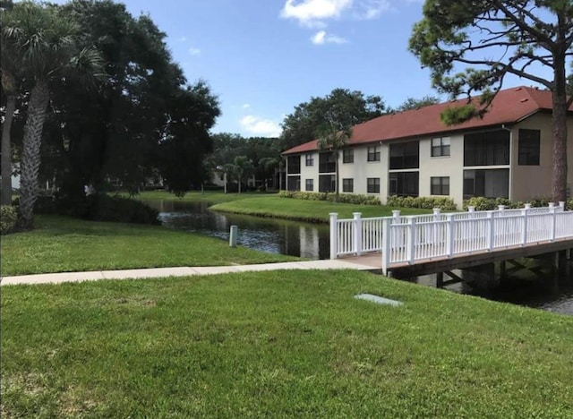 surrounding community featuring a yard and a water view