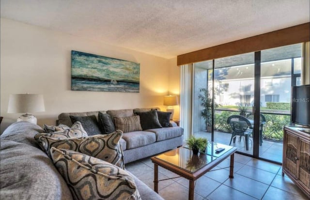 living room with light tile floors and a textured ceiling