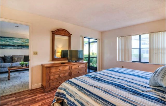 bedroom with dark tile flooring and access to exterior