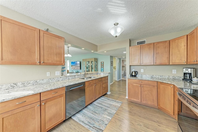 kitchen with light stone countertops, range, light hardwood / wood-style flooring, stainless steel dishwasher, and a textured ceiling