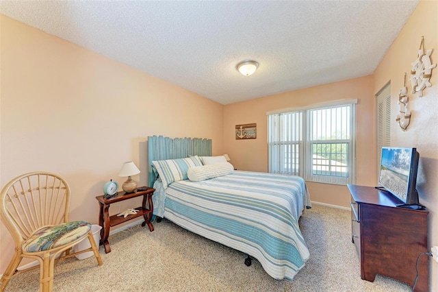 carpeted bedroom featuring a textured ceiling