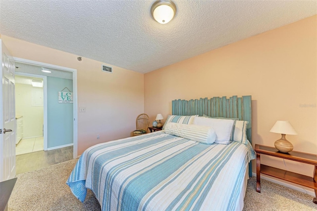 tiled bedroom featuring a textured ceiling